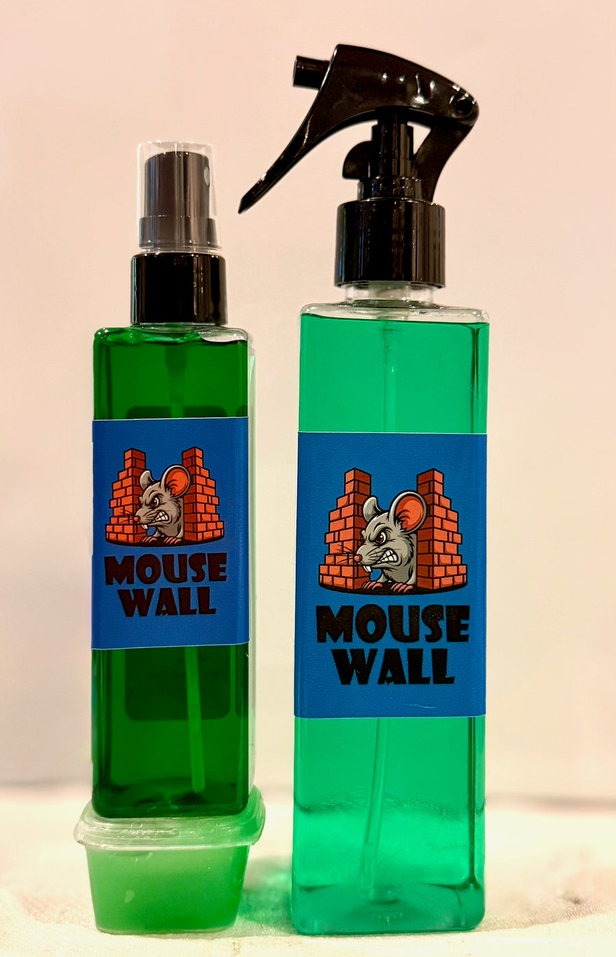 Extra Strength Mouse Wall — green spray bottles with a tub of Mouse Wall Paste